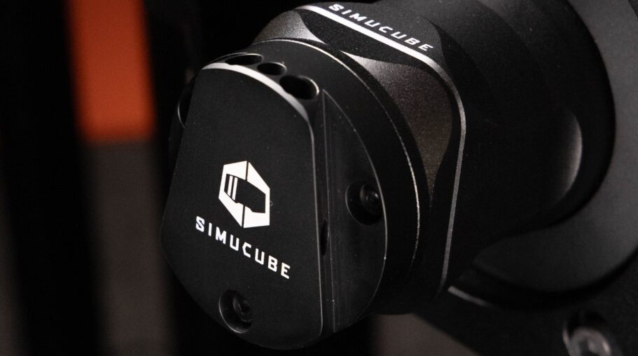 Simucube 3 direct drive wheelbase fitted with the Simucube 2-to-3 adapter, showing a Simucube 2 formula-style wheel being attached in a sim racing rig