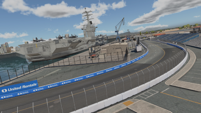 Sim racer using a triple-monitor rig with wheel and pedals to test iRacing during Season 3 Patch 2 update