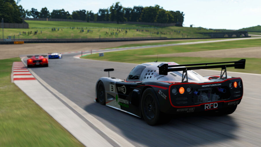 Cockpit view inside a race car in Automobilista 2 with a sim racing rig and OBS streaming setup visible in the foreground, illustrating audio capture during recording